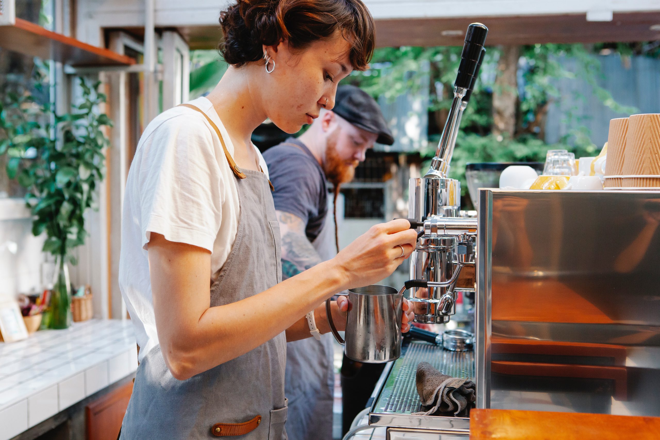 cafe employee making coffee