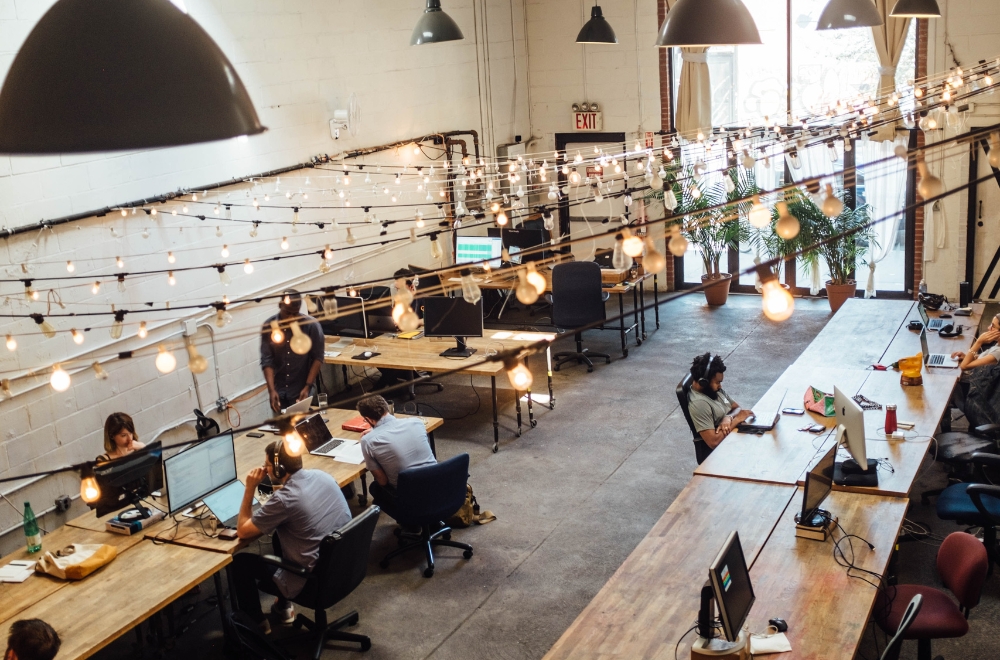 People working at desks in brightly lit office